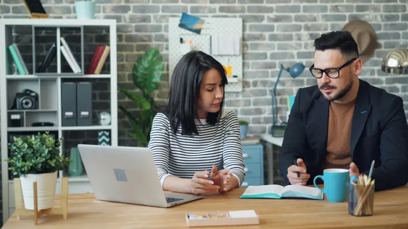 Support-style workspace with headphones and a laptop